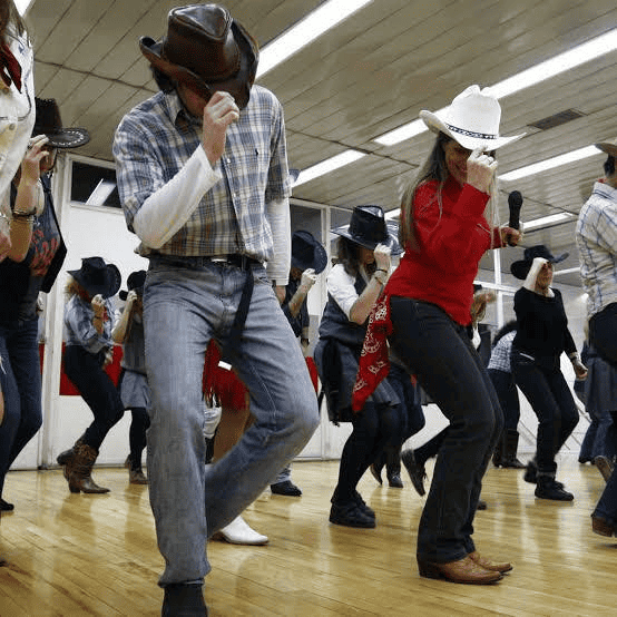 People enjoying a lively country line dance.